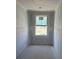 Bright bedroom awaits customization with a large window, showcasing ample space and unfinished walls ready for painting at 22113 Amberbush Ct., Mount Dora, FL 32757