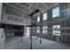 Unfinished living room featuring drywall, large windows, scaffold and open floor plan at 22113 Amberbush Ct., Mount Dora, FL 32757