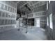 Living room under construction with scaffolding, showcasing its spacious layout at 22113 Amberbush Ct., Mount Dora, FL 32757