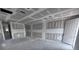 Unfinished living room showing bare concrete floors, drywall, and a door at 22113 Amberbush Ct., Mount Dora, FL 32757