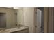 Bright bathroom with double sinks, a large mirror, and a separate toilet room at 222 Glass Onion Dr, Groveland, FL 34737