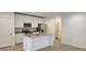 Open-concept kitchen featuring a center island, stainless steel appliances, and tile flooring at 222 Glass Onion Dr, Groveland, FL 34737