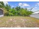 Spacious backyard with a wooden fence, lush greenery, and plenty of room for outdoor activities and relaxation at 232 Oxford Rd, Davenport, FL 33896