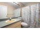 Bathroom featuring a combined sink and vanity, toilet, and shower with curtain at 232 Oxford Rd, Davenport, FL 33896
