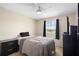 Comfortable bedroom with a ceiling fan, a window view and dark wood furniture at 232 Oxford Rd, Davenport, FL 33896