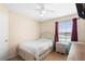 Bedroom with neutral paint, bed, ceiling fan, and window at 232 Oxford Rd, Davenport, FL 33896