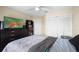Cozy bedroom features a ceiling fan, neutral paint and ample closet space at 232 Oxford Rd, Davenport, FL 33896