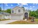 Charming two-story home with a well-manicured lawn, attached two car garage, and welcoming front entrance at 232 Oxford Rd, Davenport, FL 33896
