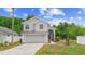 Charming two-story home featuring a well-manicured front yard and attached two-car garage at 232 Oxford Rd, Davenport, FL 33896