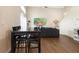 A living room and dining area featuring wood floors, a dark table and a comfortable sofa at 232 Oxford Rd, Davenport, FL 33896