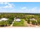 Expansive estate with lush landscaping, a detached garage, and a charming single-story home on a sprawling lot at 23203 Outback Ln, Eustis, FL 32736