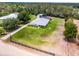 Aerial view of the home showing spacious yard and mature trees at 23203 Outback Ln, Eustis, FL 32736