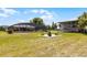 Spacious backyard with screened-in pool area, fire pit, and covered boat storage, ideal for outdoor living at 23203 Outback Ln, Eustis, FL 32736