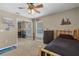 Bedroom showcasing fan, window, sports themed decor, and sliding mirrored closet doors at 23203 Outback Ln, Eustis, FL 32736