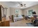 Bedroom featuring neutral walls, ceiling fan, daybed, and desk with adjacent exercise machine and carpet floors at 23203 Outback Ln, Eustis, FL 32736