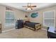 Bedroom featuring fan, window, sports themed decor, and wood-frame bed at 23203 Outback Ln, Eustis, FL 32736