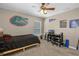 Bedroom showcasing fan, window, desk, and sports themed decor at 23203 Outback Ln, Eustis, FL 32736