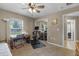 Bedroom featuring fan, window, exercise bike, desk, and mirrored closet doors at 23203 Outback Ln, Eustis, FL 32736