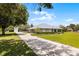 Ranch home featuring a long driveway, well-manicured landscaping, and a spacious layout with a boat storage building at 23203 Outback Ln, Eustis, FL 32736