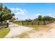 Gated home with a long driveway and expansive lawn, offering privacy and a sense of grandeur at 23203 Outback Ln, Eustis, FL 32736