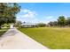 Traditional home with a long driveway and spacious front yard, offering curb appeal and a sense of privacy at 23203 Outback Ln, Eustis, FL 32736