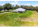 Expansive lawn surrounds this single-story home with neutral tones at 23203 Outback Ln, Eustis, FL 32736
