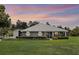 Charming one-story home with landscaped lawn and a well-maintained yard and separate garage at 23203 Outback Ln, Eustis, FL 32736