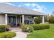 Charming front porch featuring blue rocking chairs and decorative plants at 23203 Outback Ln, Eustis, FL 32736