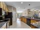 Open concept kitchen with granite counters, stainless appliances, and view to dining area at 23203 Outback Ln, Eustis, FL 32736