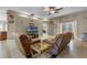 Comfortable living room featuring two reclining sofas, a glass coffee table and overhead fan at 23203 Outback Ln, Eustis, FL 32736