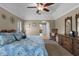 Primary suite featuring tray ceilings, sitting area, and ensuite bathroom at 23203 Outback Ln, Eustis, FL 32736