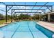 Sparkling pool with screened enclosure, water feature, lush landscaping and ample space for outdoor enjoyment at 23203 Outback Ln, Eustis, FL 32736