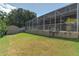 Well-maintained backyard with an enclosed patio and storage shed on grass at 269 Englenook Dr, Debary, FL 32713