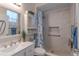 Bright bathroom with a marble shower, sleek vanity, and decorative storage at 269 Englenook Dr, Debary, FL 32713