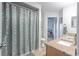 Bathroom with double sinks, granite counters, and a shower with tiled walls at 269 Englenook Dr, Debary, FL 32713