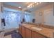 Bathroom boasts double sinks, granite countertops, and a decorative shower curtain at 269 Englenook Dr, Debary, FL 32713