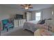 Cozy bedroom with a ceiling fan, TV, and window letting in natural light at 269 Englenook Dr, Debary, FL 32713