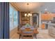 Dining room with a wood accent wall, dining table set, chandelier, and lots of natural light at 269 Englenook Dr, Debary, FL 32713
