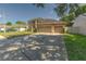 Two-story home featuring a well-kept front lawn, long driveway and three-car garage at 269 Englenook Dr, Debary, FL 32713