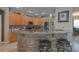 Eat-in kitchen features a stone countertop bar with barstool seating and light wood cabinets at 269 Englenook Dr, Debary, FL 32713