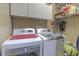 Clean laundry area features a washer, dryer, and overhead cabinet storage at 269 Englenook Dr, Debary, FL 32713