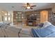 Cozy living room features a decorative wood accent wall, ceiling fan and comfortable sectional couch at 269 Englenook Dr, Debary, FL 32713