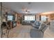 Spacious living room with hardwood floors, ceiling fan, comfortable seating, and cozy fireplace at 269 Englenook Dr, Debary, FL 32713