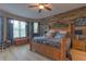 Bedroom suite boasts a decorative wood accent wall, ceiling fan, and lots of natural light at 269 Englenook Dr, Debary, FL 32713