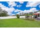 Landscaped backyard with white fence and view of deck and swimming pool at 275 Tollgate Trl, Longwood, FL 32750