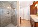 Tiled walk-in shower featuring glass door and side, paired with granite vanity at 275 Tollgate Trl, Longwood, FL 32750