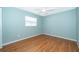 Bedroom with hardwood floors, ceiling fan, and natural light from window at 275 Tollgate Trl, Longwood, FL 32750