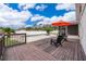 Wooden deck with chairs and umbrella overlooking the pool and backyard at 275 Tollgate Trl, Longwood, FL 32750