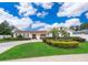 Charming single-story home featuring a manicured lawn, mature landscaping, and a circular driveway at 275 Tollgate Trl, Longwood, FL 32750