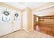 Open foyer with tiled flooring, decorative double doors, and an entryway leading to a spacious living area with laminate floors at 275 Tollgate Trl, Longwood, FL 32750